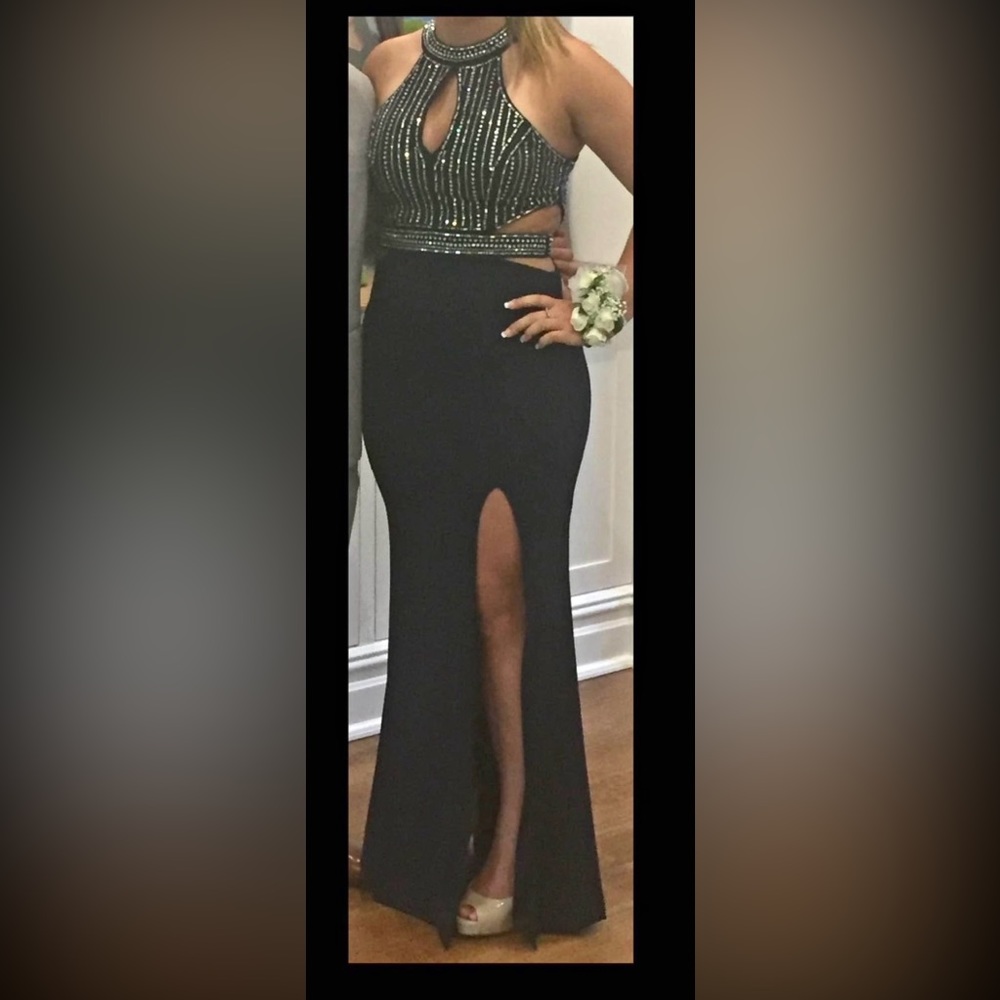 Navy blue prom dress with beading on the top, cut outs, and leg slit